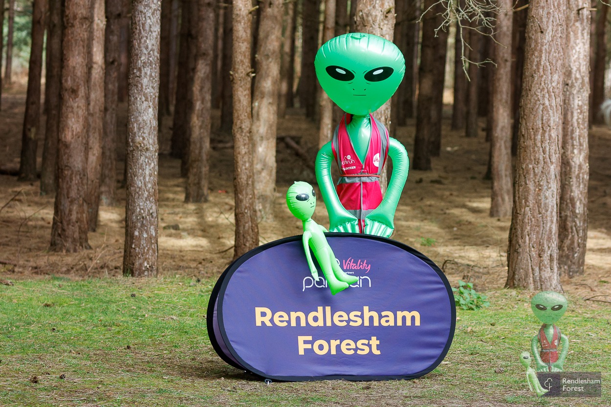 Ziggy and a Mini Ziggy beside the Rendlesham Forest parkrun banner